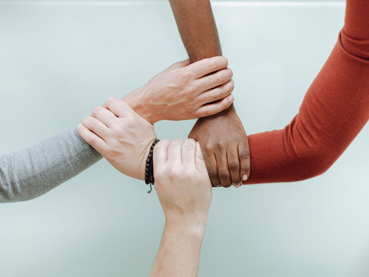 A diverse group of hands joined together in a circle